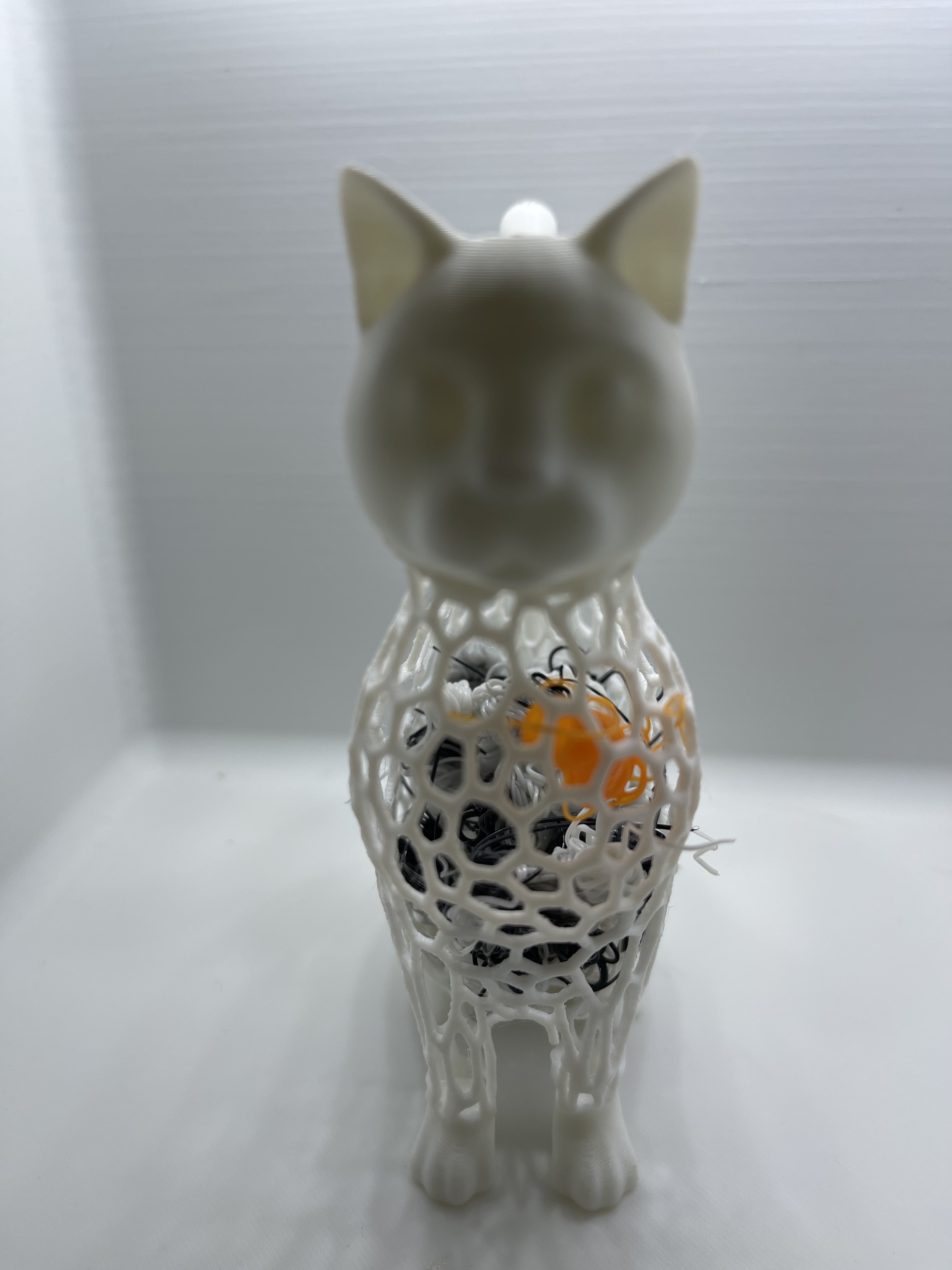 white decorative cat with colors inside the body